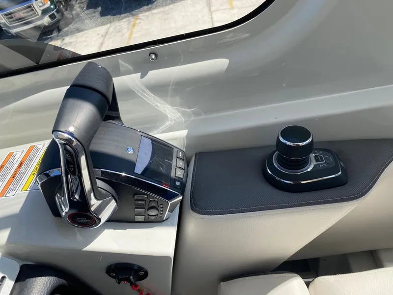 Slide: The Image of The image shows the helm of a Crownline 310 CRX boat with modern controls. - 15
