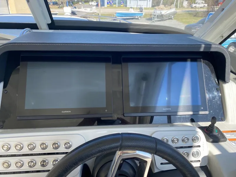 Slide: The Image of Dashboard of the Crownline 310 CRX with two large screens and control elements. - 19