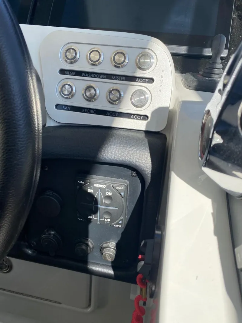Slide: The Image of Close-up of a Crownline 310 CRX helm with switches and control knobs. - 17