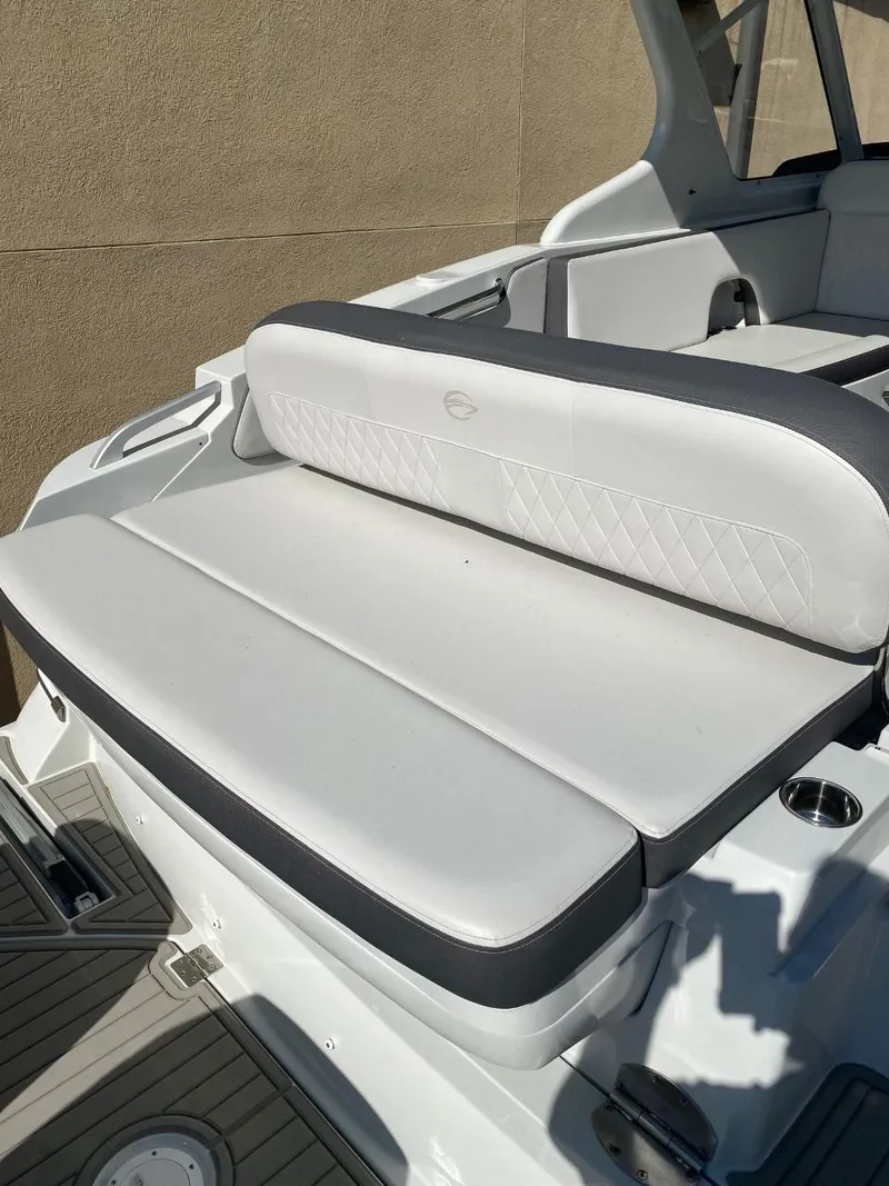 Slide: The Image of The image shows the white upholstery of a 2023 Crownline 310 CRX. - 6
