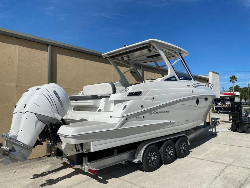 Slide: The Image of A 2023 Crownline 310 CRX boat on a trailer, featuring a Honda outboard motor. - 4