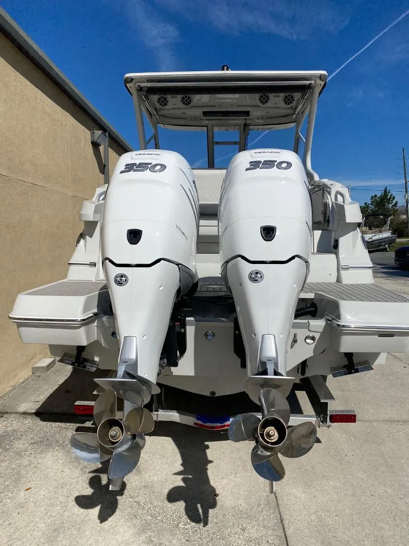 Slide: The Image of Two powerful outboard engines on a modern boat, positioned on a concrete surface. - 5
