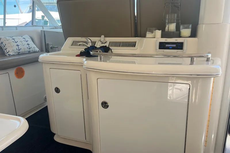 Slide: The Image of Interior of 2002 Sea Ray 480 Motor Yacht with kitchenette and seating area. - 4