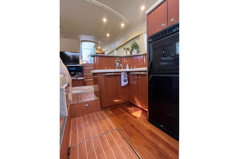 Slide: The Image of Luxurious interior of 2002 Sea Ray 480 Motor Yacht with wood cabinetry and modern appliances. - 20