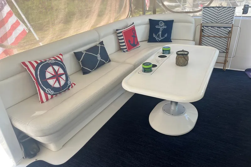Slide: The Image of Interior of 2002 Sea Ray 480 Motor Yacht with nautical-themed cushions and table. - 3