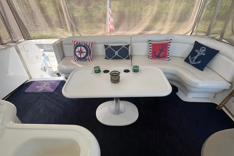 Slide: The Image of Luxurious 2002 Sea Ray 480 Motor Yacht interior with nautical-themed cushions and elegant seating area. - 1