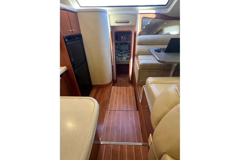 Slide: The Image of Interior of 2002 Sea Ray 480 Motor Yacht with wood flooring and beige seating. - 15