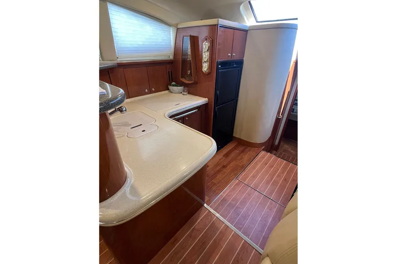 Slide: The Image of Luxurious 2002 Sea Ray 480 Motor Yacht interior with elegant wood finishes and modern amenities. - 16