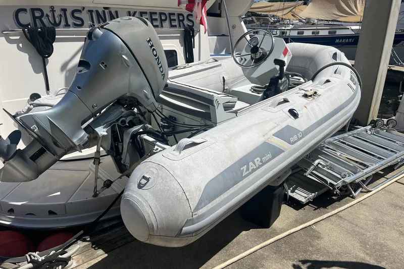 Slide: The Image of Inflatable boat with Honda motor docked beside 2002 Sea Ray 480 Motor Yacht. - 9