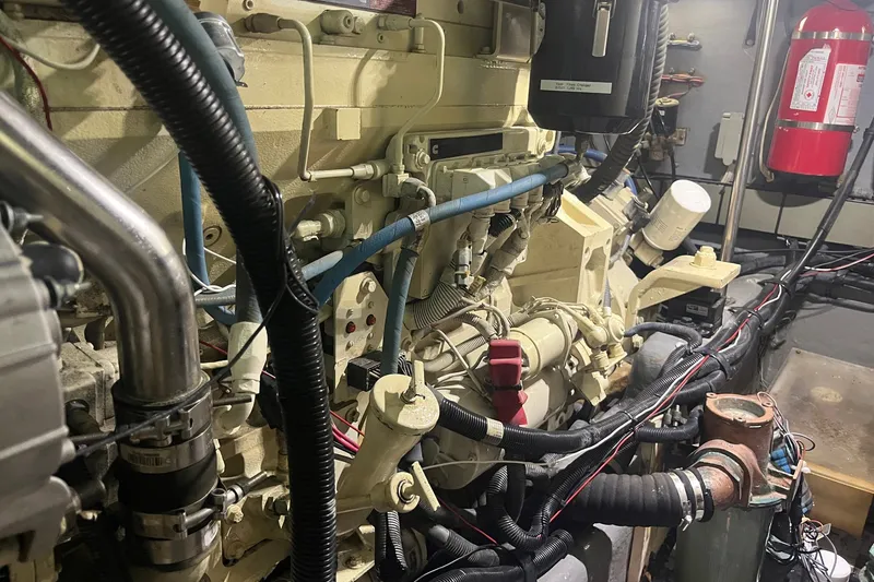 Slide: The Image of Engine room of a 2002 Sea Ray 480 Motor Yacht, showcasing mechanical components and wiring. - 12