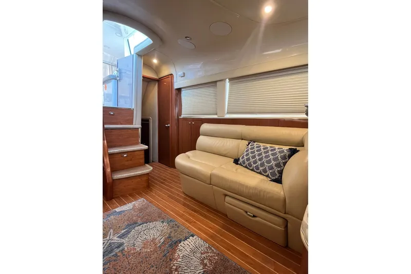 Slide: The Image of Luxurious interior of 2002 Sea Ray 480 Motor Yacht with plush seating and elegant wood finishes. - 22