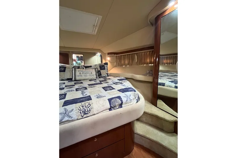 Slide: The Image of Luxurious bedroom interior of 2002 Sea Ray 480 Motor Yacht with nautical-themed bedding. - 26