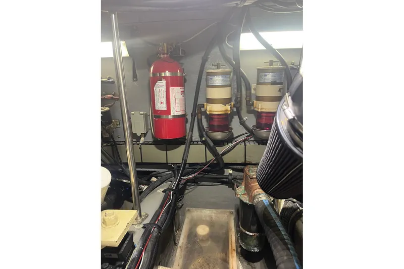 Slide: The Image of Engine room of 2002 Sea Ray 480 Motor Yacht with fire extinguisher and fuel filters. - 13