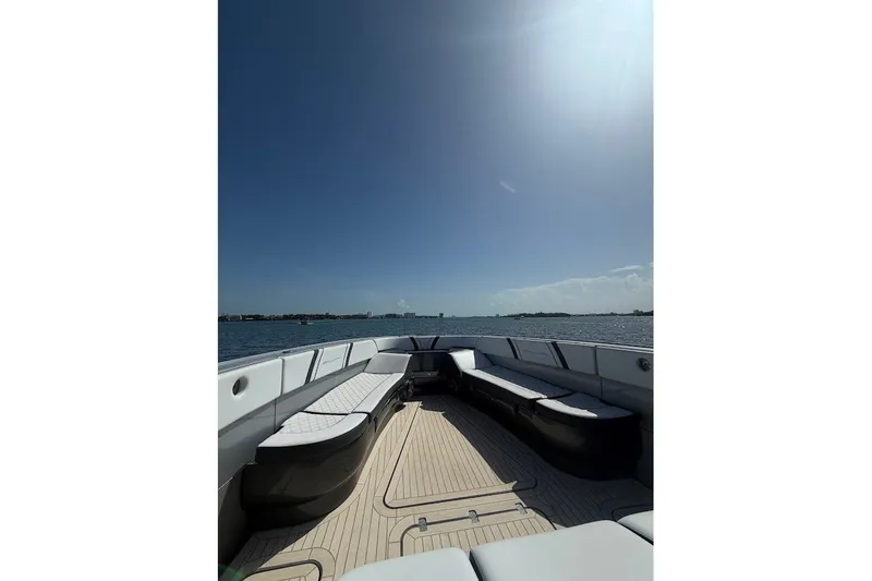 Slide: The Image of 2019 Midnight Express 43 Open boat with spacious deck and seating, cruising on calm waters. - 15
