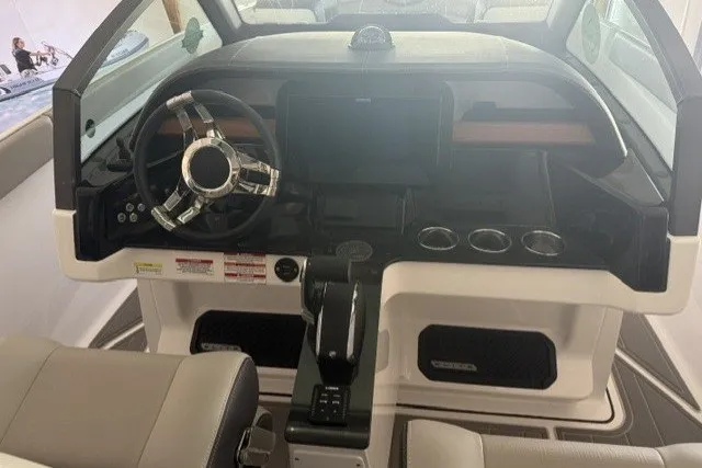 Slide: The Image of Cockpit of 2027 Monterey Elite 27 SD boat with modern steering and controls. - 18