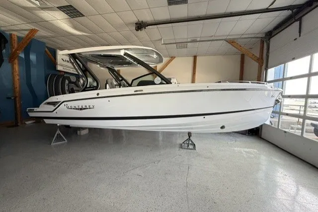 Slide: The Image of 2027 Monterey Elite 27 SD boat displayed in a showroom, side view. - 1