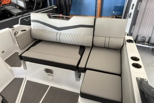 Slide: The Image of 2027 Monterey Elite 27 SD boat interior with cushioned seating and cup holders. - 4