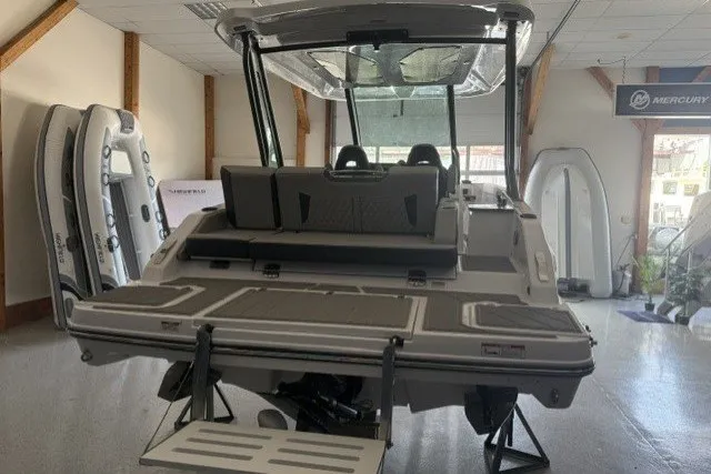 Slide: The Image of 2027 Monterey Elite 27 SD boat displayed in showroom, featuring sleek design and modern amenities. - 2