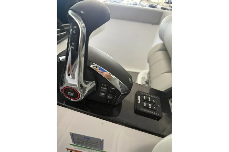 Slide: The Image of Throttle control and dashboard of a 2027 Monterey Elite 27 SD boat. - 8