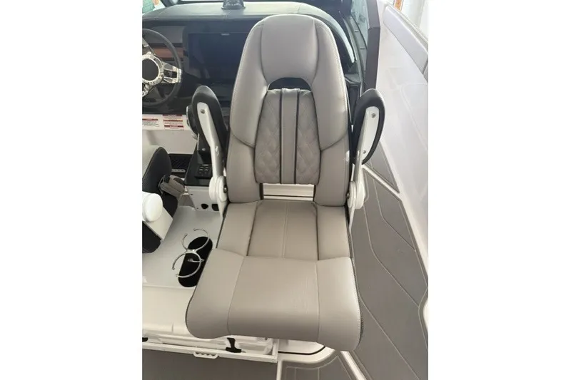 Slide: The Image of Captain's seat in 2027 Monterey Elite 27 SD boat, featuring sleek gray upholstery. - 3