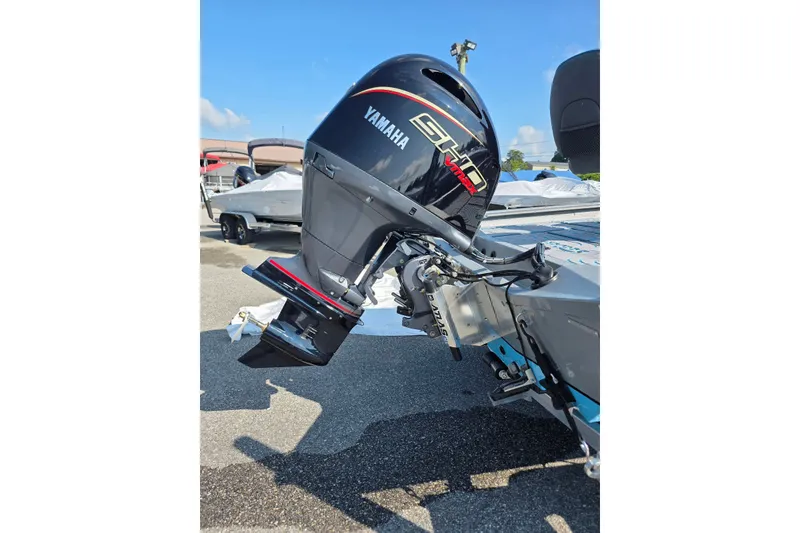 Slide: The Image of 2027 Xpress H20B Bay boat with Yamaha outboard motor in a sunny marina. - 5