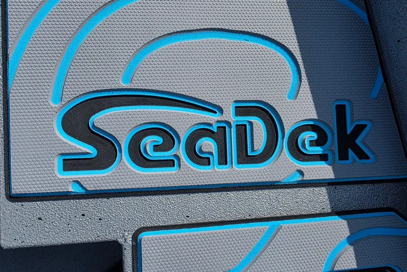 Slide: The Image of SeaDek logo on Xpress H20B Bay boat flooring, 2027 model, featuring blue and gray design. - 10
