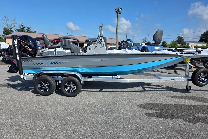 The Image of 2027 Xpress H20B Bay boat on trailer, featuring sleek design and modern equipment. - 1