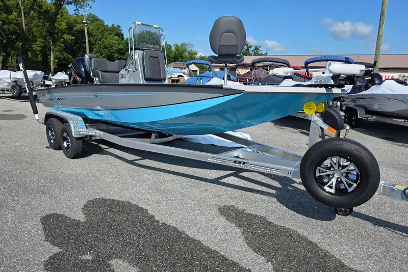 Slide: The Image of 2027 Xpress H20B Bay boat on trailer, parked outdoors under clear sky. - 6