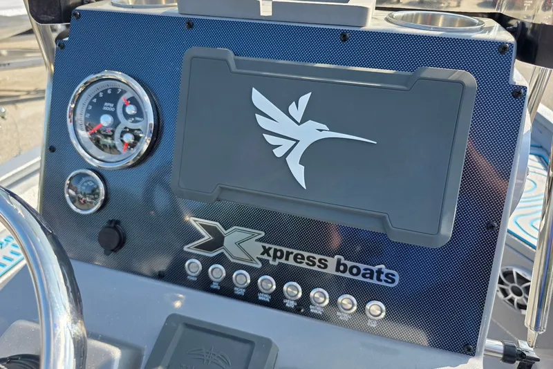 Slide: The Image of Dashboard of 2027 Xpress H20B Bay boat with logo and gauges. - 16