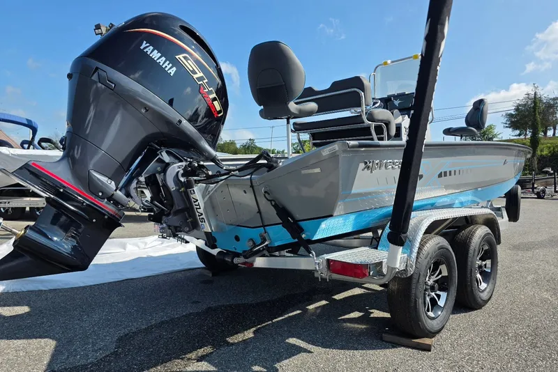Slide: The Image of 2027 Xpress H20B Bay boat with Yamaha engine on a trailer, parked outdoors. - 3