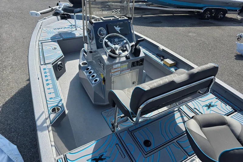 Slide: The Image of 2027 Xpress H20B Bay boat interior with modern console and seating. - 7
