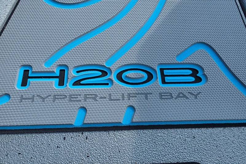 Slide: The Image of Xpress H20B Bay 2027 boat logo with blue accents on textured surface. - 9