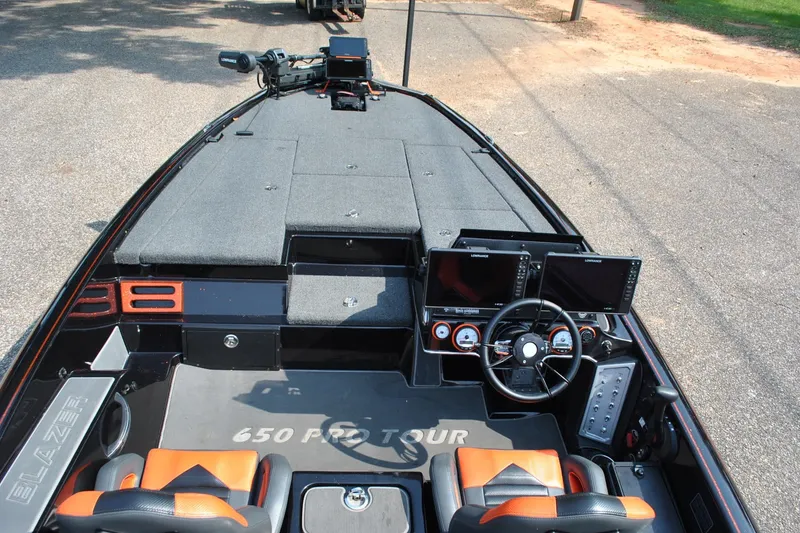 Slide: The Image of 2021 Blazer 650 Pro Tour boat interior with dual screens and steering wheel. - 9