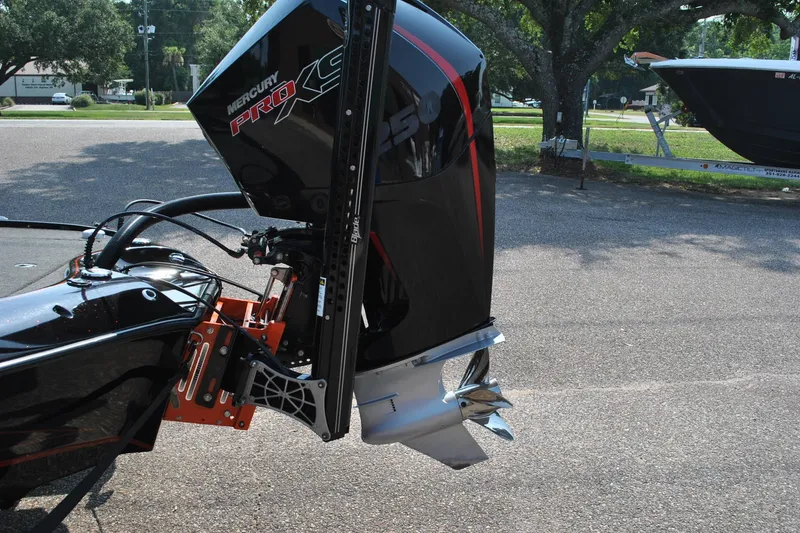 Slide: The Image of 2021 Blazer 650 Pro Tour with Mercury Pro XS outboard motor in a parking lot. - 7