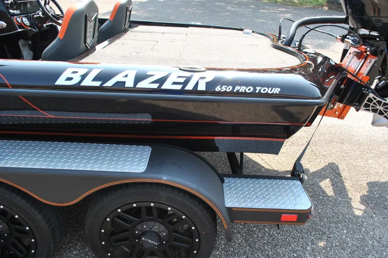 Slide: The Image of 2021 Blazer 650 Pro Tour boat on trailer with custom wheels and step. - 8