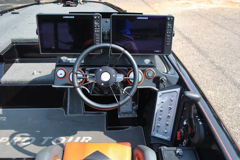 Slide: The Image of 2021 Blazer 650 Pro Tour boat dashboard with dual Lowrance displays and steering wheel. - 13