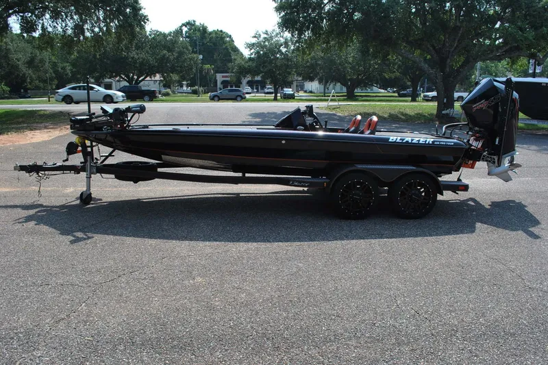 Slide: The Image of 2021 Blazer 650 Pro Tour boat on trailer, parked outdoors. - 4