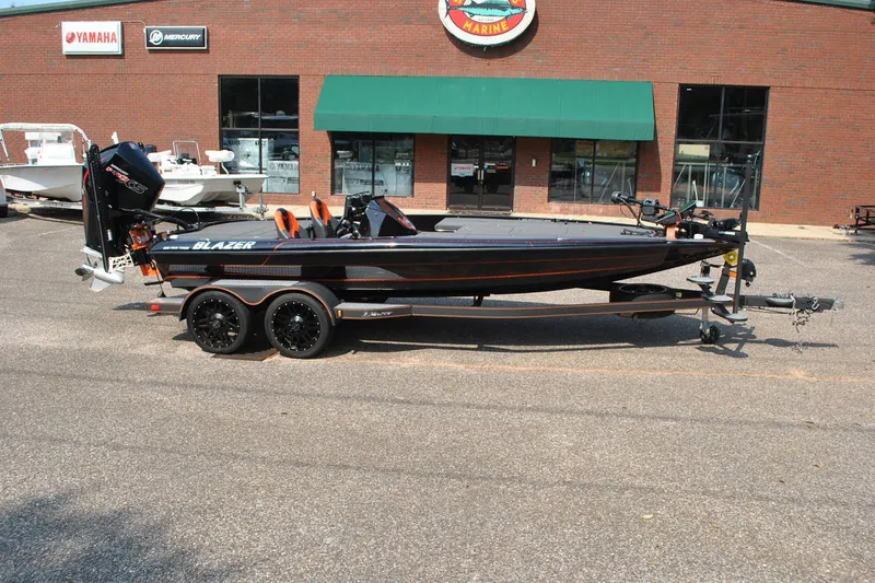Slide: The Image of 2021 Blazer 650 Pro Tour boat on trailer outside marine dealership. - 1