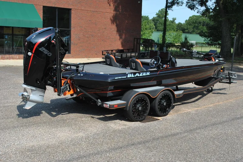 Slide: The Image of 2021 Blazer 650 Pro Tour boat with powerful engine, parked outdoors on a trailer. - 3