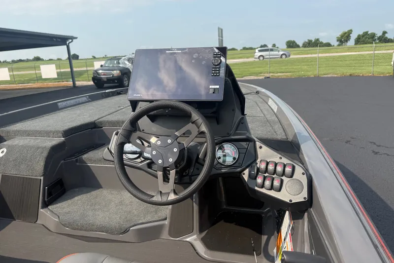 Slide: The Image of Cockpit of 2027 Skeeter ZXE20 boat with steering wheel and control panel. - 21
