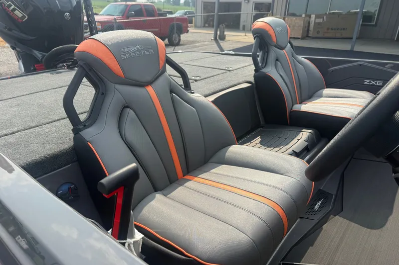 Slide: The Image of 2027 Skeeter ZXE20 boat interior with sleek gray and orange seats. - 23