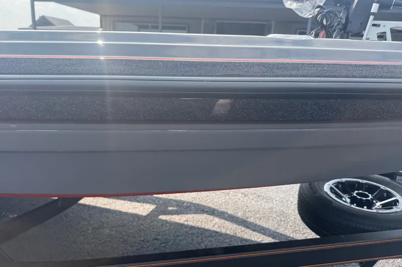 Slide: The Image of 2027 Skeeter ZXE20 boat hull with sleek design and visible trailer wheel. - 15
