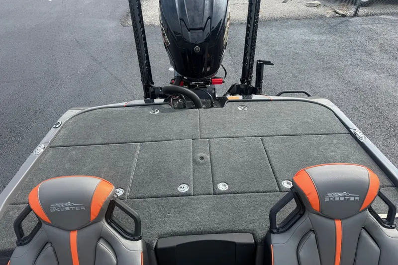 Slide: The Image of 2027 Skeeter ZXE20 boat interior with dual seats and motor, showcasing sleek design. - 27