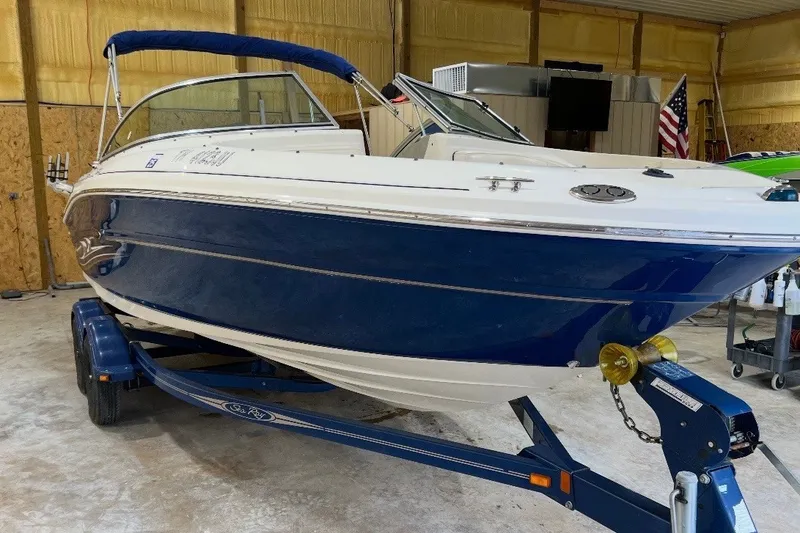 Slide: The Image of 2004 Sea Ray 200 Select boat on trailer in indoor storage. - 2