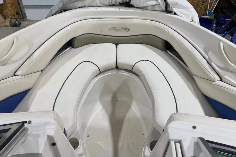 Slide: The Image of Interior of a 2004 Sea Ray 200 Select boat with white cushioned seating. - 10