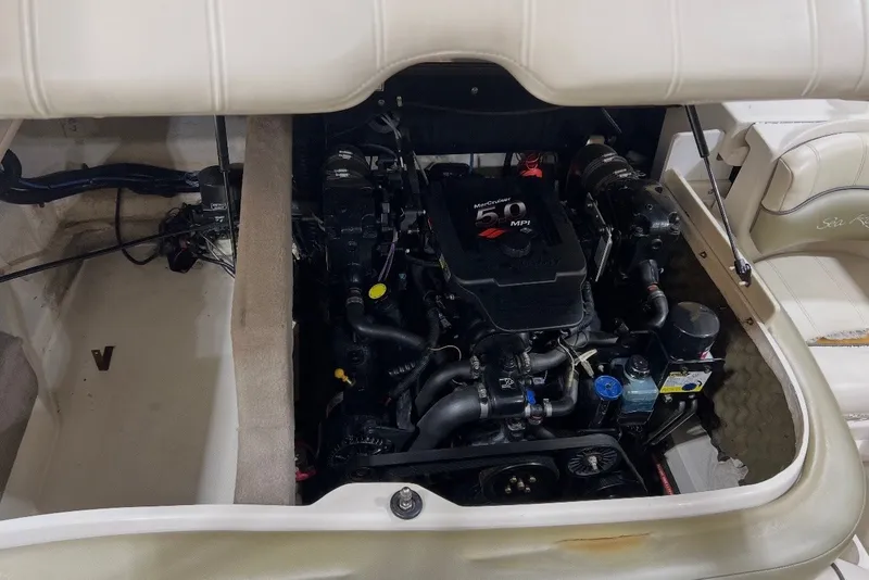 Slide: The Image of Engine compartment of a 2004 Sea Ray 200 Select boat, featuring a MerCruiser 5.0 MPI engine. - 7