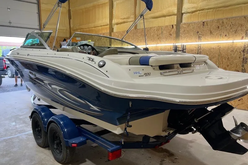 Slide: The Image of 2004 Sea Ray 200 Select boat on trailer in garage setting. - 4