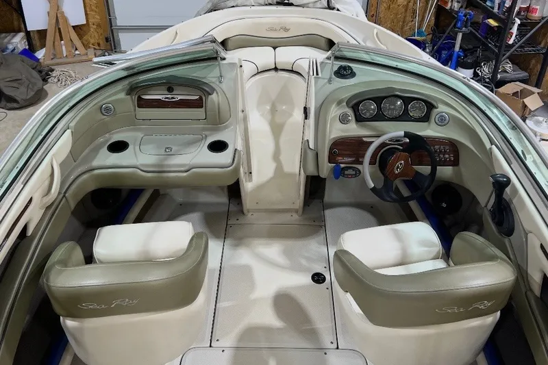 Slide: The Image of Interior of a 2004 Sea Ray 200 Select boat, featuring steering wheel and seating. - 5