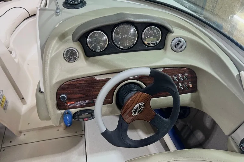 Slide: The Image of Dashboard of a 2004 Sea Ray 200 Select boat with steering wheel and gauges. - 16