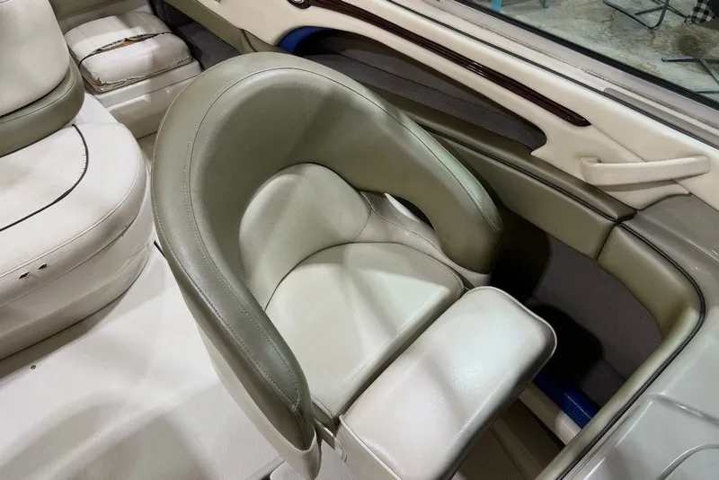 Slide: The Image of 2004 Sea Ray 200 Select boat interior with beige leather seating. - 13